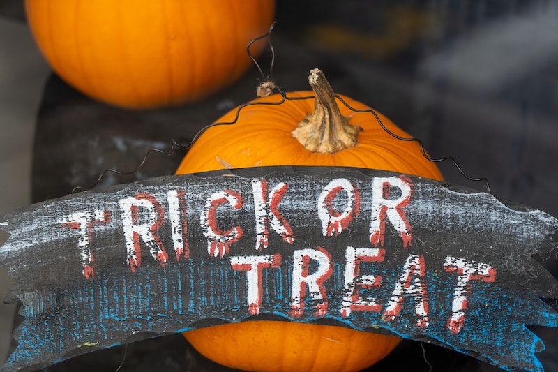 Trick Or Treat Sign in Front of Pumpkins